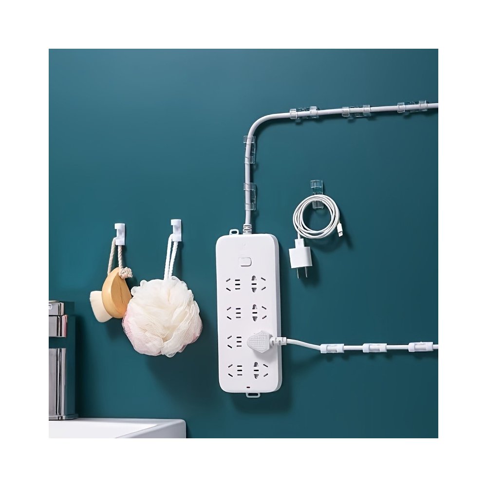 White adhesive cable clips mounted on a wall